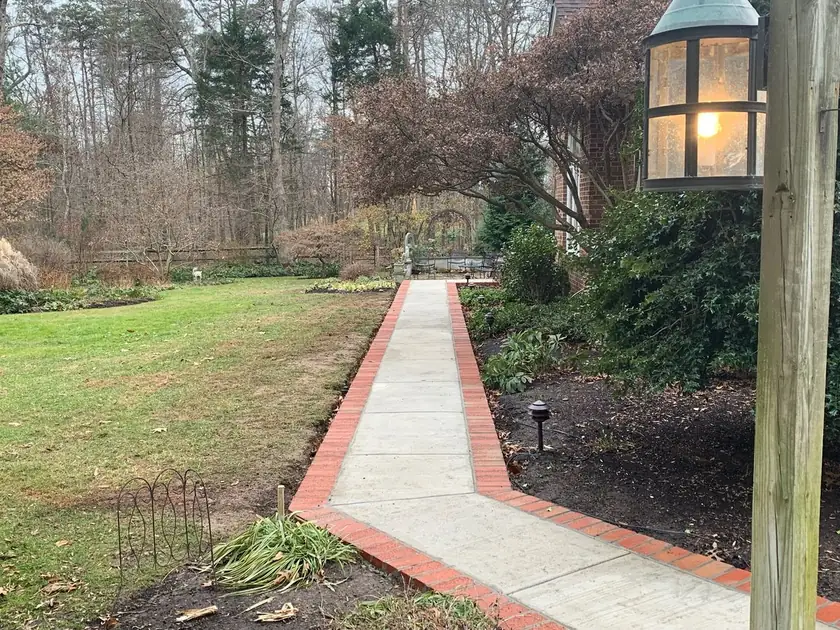 Concrete walkway with a red brick border by MG Minor Construction, concrete contractor serving Orlean VA