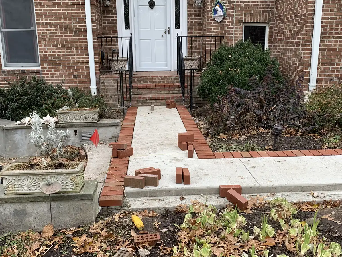 After: concrete front walkway with brick border