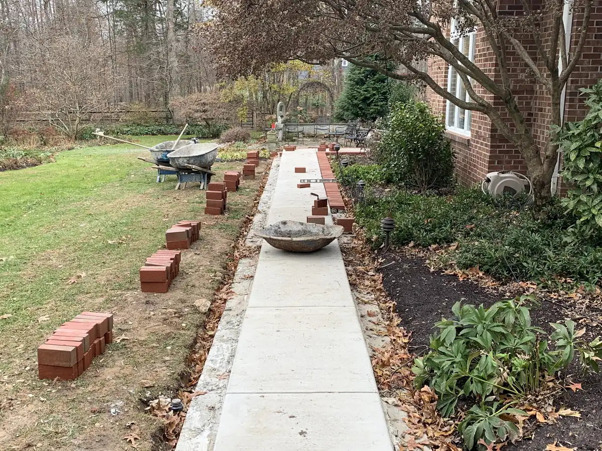 Concrete walkway with the brick border going in by MG Minor Construction in Marshall VA