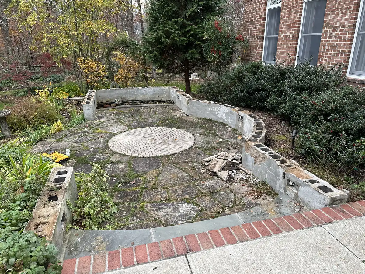 Before: courtyard patio with the old seating wall stripped to block