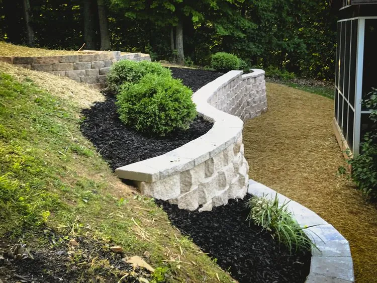 Curved block retaining wall with landscaping by MG Minor Construction, concrete contractor serving Flint Hill VA