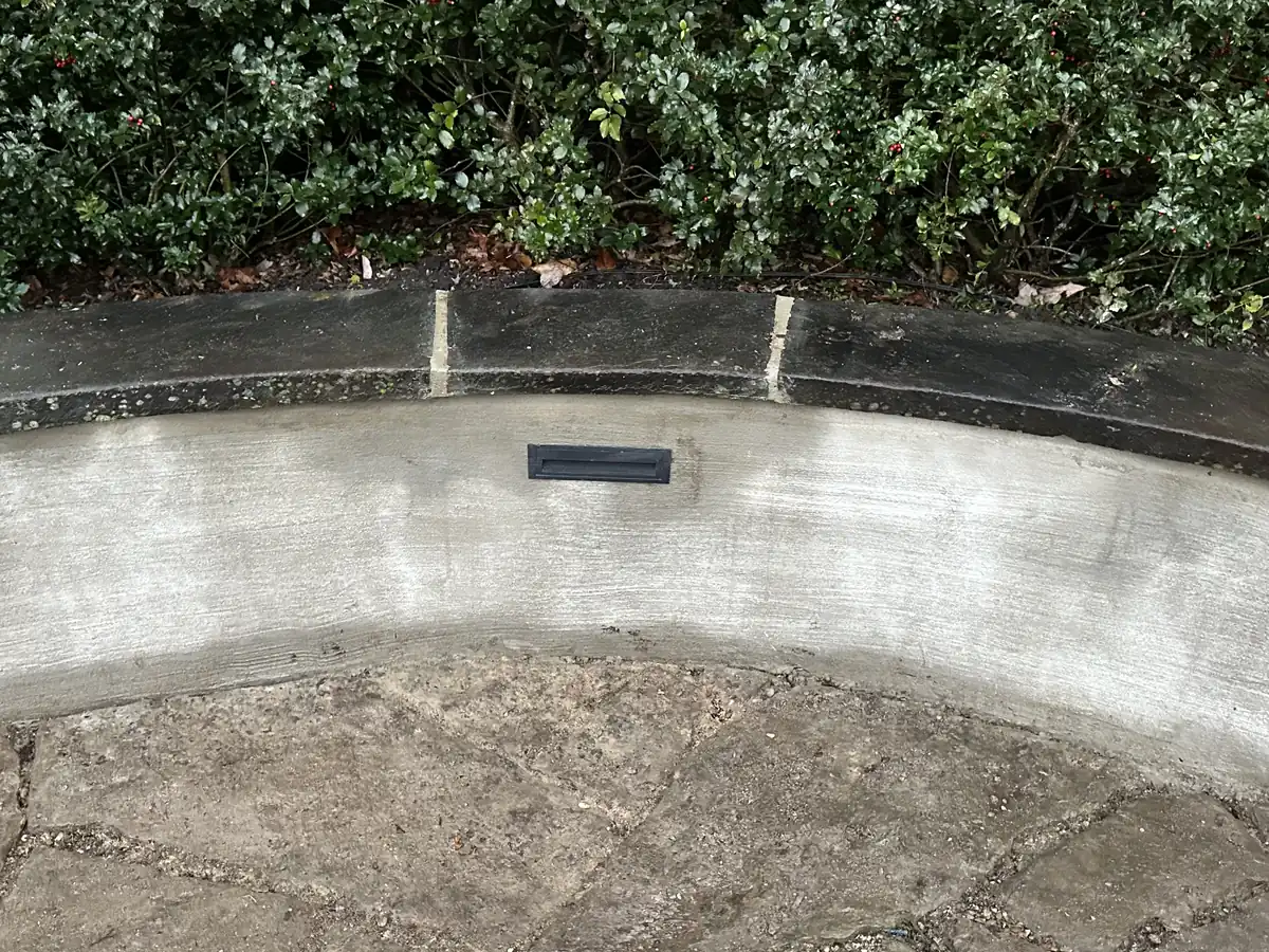 Curved seating wall with stone cap and built in light by MG Minor Construction in Marshall VA