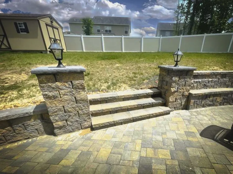 Stone steps and pillars on a paver patio by MG Minor Construction, serving Flint Hill VA